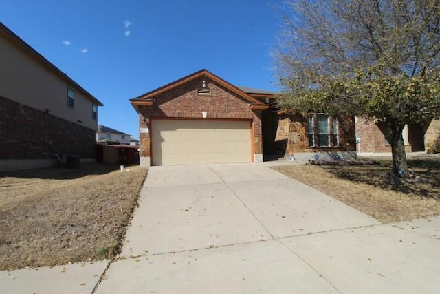 ranch-style house with driveway, brick siding, an attached garage, and roof mounted solar panels