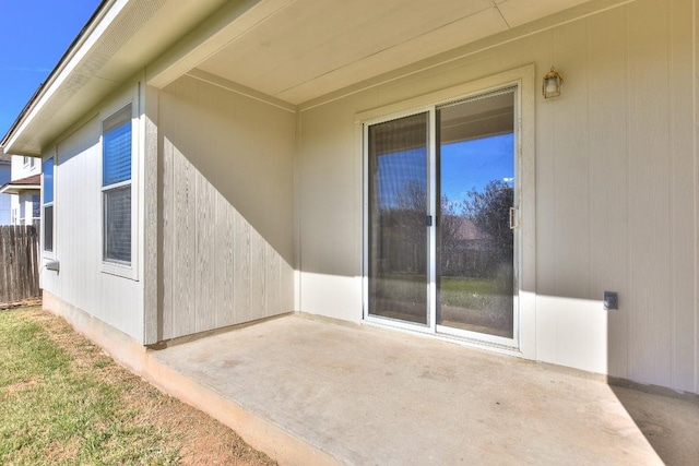 view of side of home featuring fence and a patio