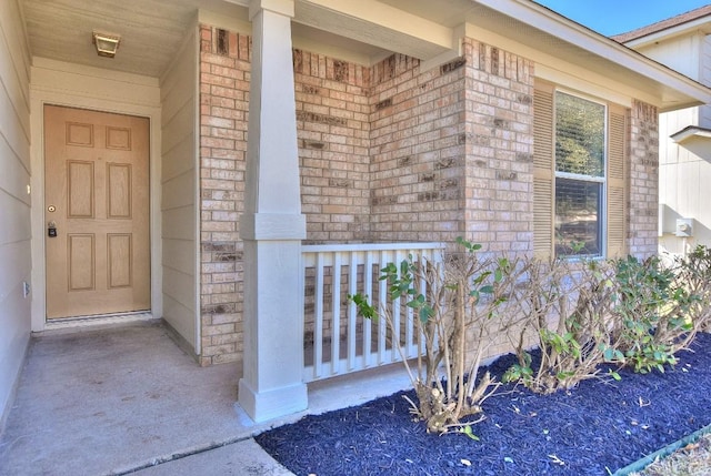 property entrance featuring brick siding