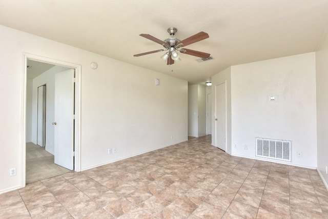 spare room with visible vents and a ceiling fan