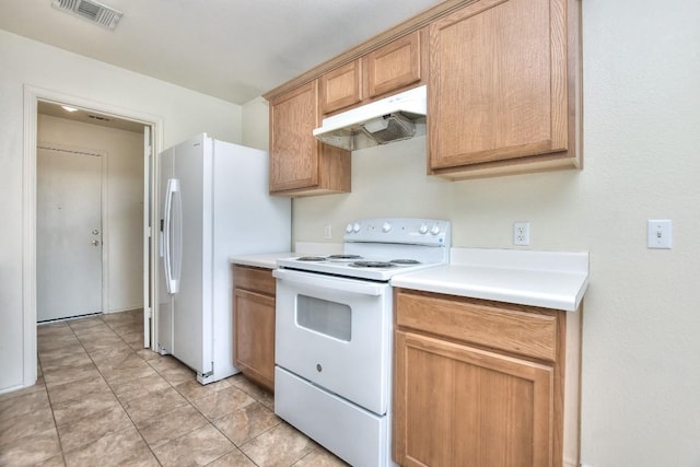 kitchen featuring white appliances, under cabinet range hood, visible vents, and light countertops