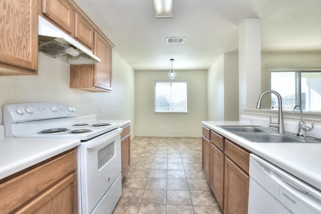 kitchen with under cabinet range hood, white appliances, a sink, visible vents, and light countertops