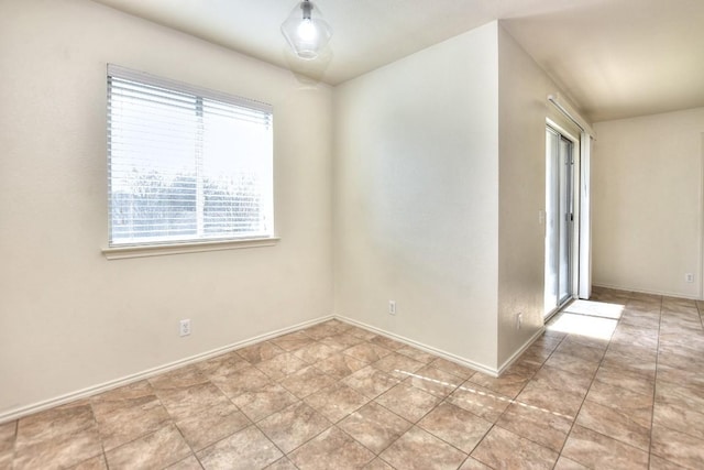 empty room featuring baseboards