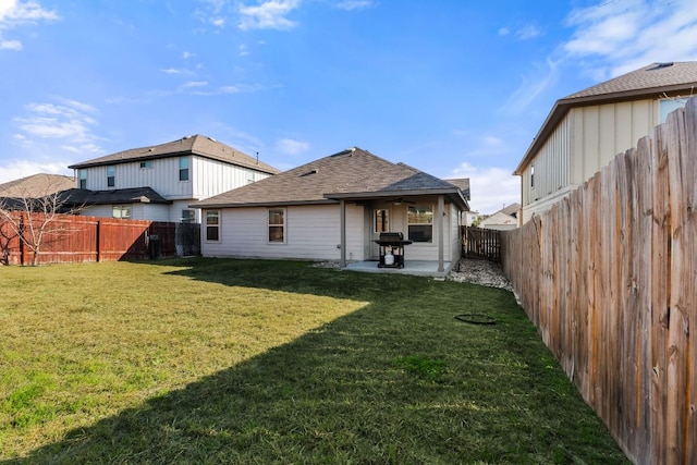 back of house with a shingled roof, a ceiling fan, a patio, a fenced backyard, and a yard