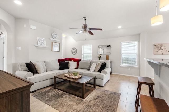 living room featuring light tile patterned floors, arched walkways, a ceiling fan, lofted ceiling, and recessed lighting