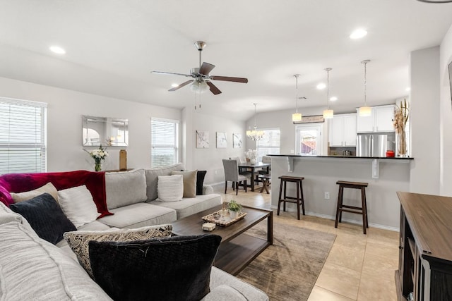 living room featuring vaulted ceiling, light tile patterned flooring, a ceiling fan, and recessed lighting