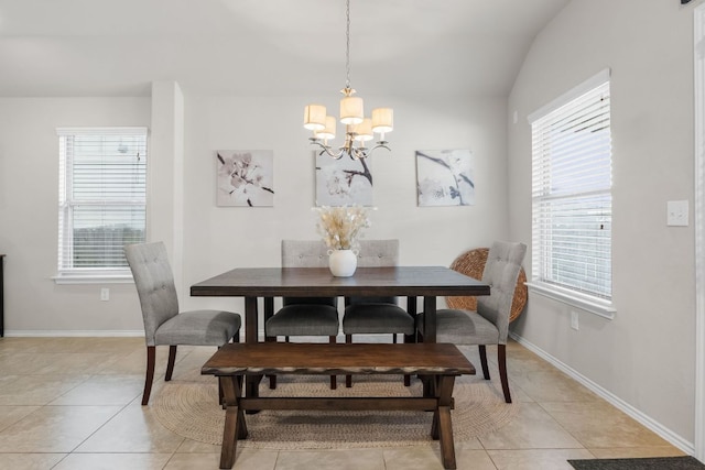 dining room with an inviting chandelier, light tile patterned floors, and baseboards