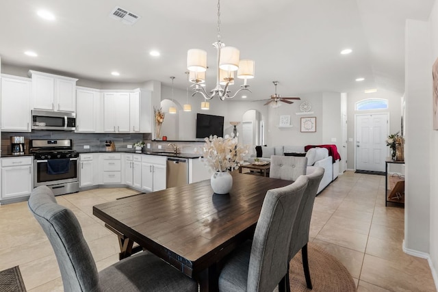 dining area featuring light tile patterned floors, visible vents, arched walkways, and recessed lighting