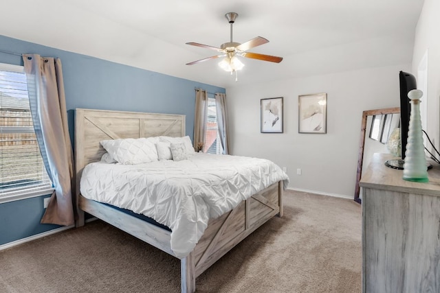 bedroom with ceiling fan, carpet, and baseboards