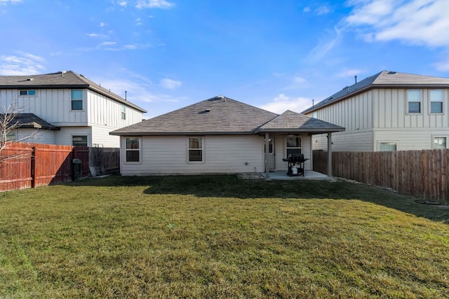 rear view of property featuring a patio area, a fenced backyard, and a yard