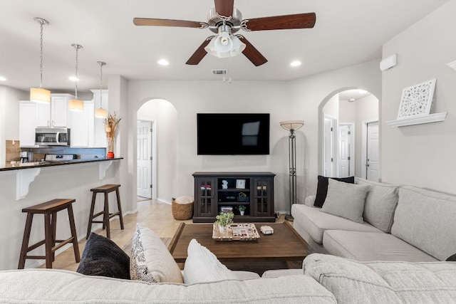 258 Noddy Rd, Buda, TX 78610 - living room featuring arched walkways, ceiling fan, recessed lighting, baseboards, and light tile patterned flooring
