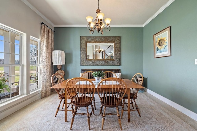 dining space with baseboards, crown molding, and an inviting chandelier