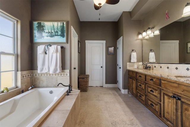 full bathroom with tile patterned floors, a sink, a garden tub, a ceiling fan, and double vanity