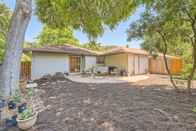 rear view of house with a patio and fence