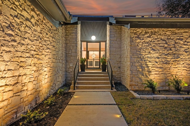 entrance to property with stone siding