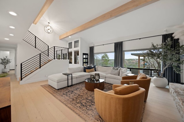 living room featuring beam ceiling, recessed lighting, stairway, an inviting chandelier, and hardwood / wood-style floors