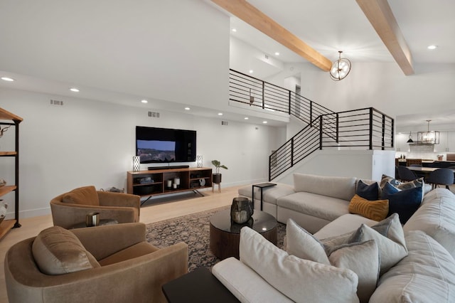 living room with recessed lighting, a notable chandelier, visible vents, stairs, and beam ceiling