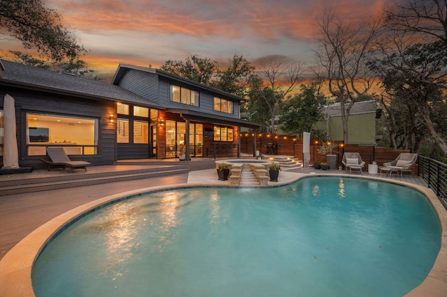 view of pool featuring a fenced in pool, a patio area, fence, a deck, and an in ground hot tub