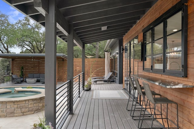 deck with an in ground hot tub and outdoor lounge area