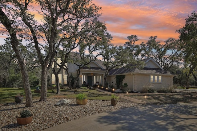 view of front of home featuring a yard and brick siding