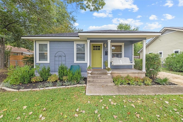 bungalow-style home with a porch and a front yard