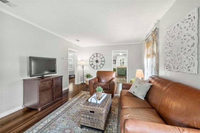 living area featuring dark wood-style floors, baseboards, visible vents, and ornamental molding