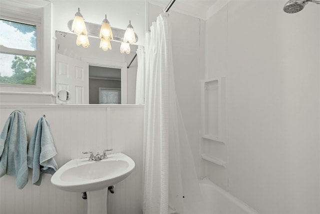 full bath featuring shower / tub combo and a sink