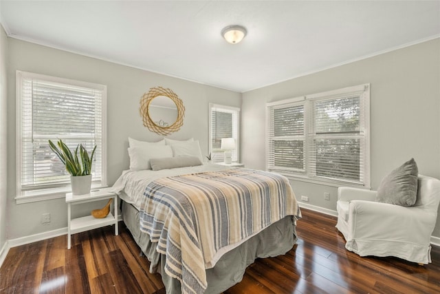 bedroom featuring hardwood / wood-style flooring and baseboards