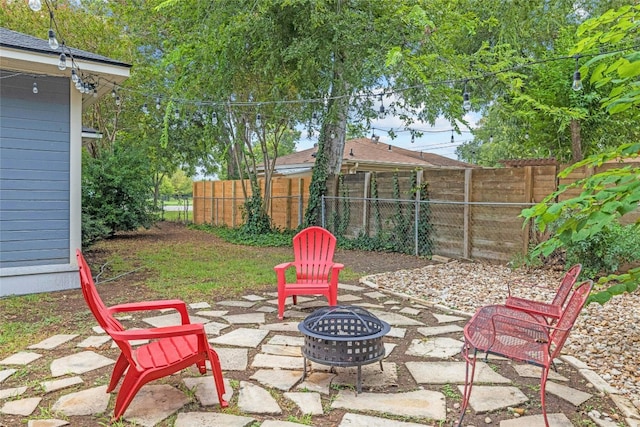 view of patio / terrace with an outdoor fire pit and fence