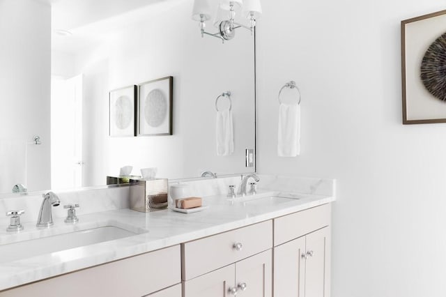 full bathroom with double vanity and a sink