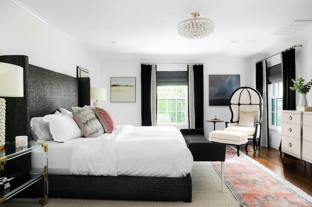 bedroom featuring multiple windows and wood finished floors