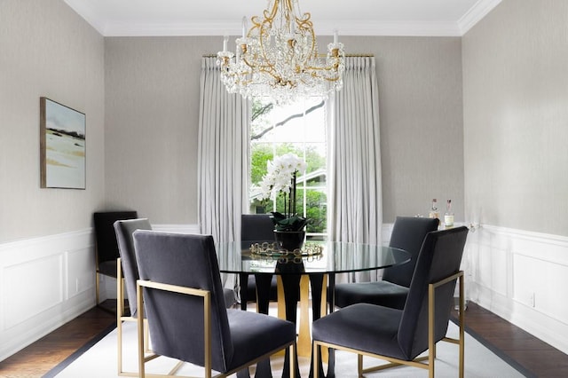 dining area featuring wainscoting, crown molding, and wood finished floors