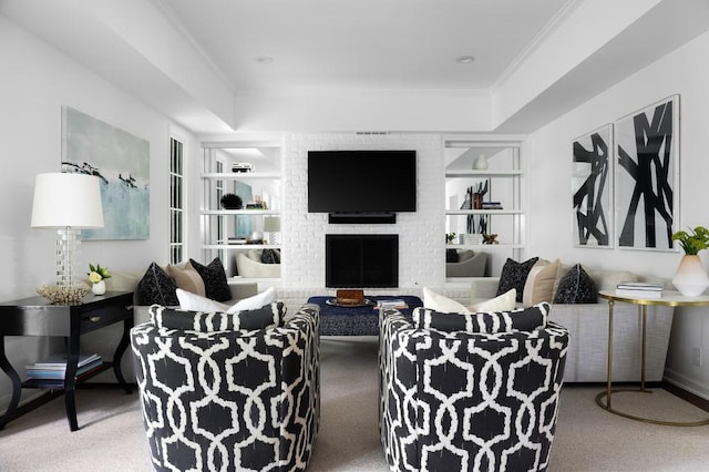 carpeted living room with a fireplace, built in features, and crown molding