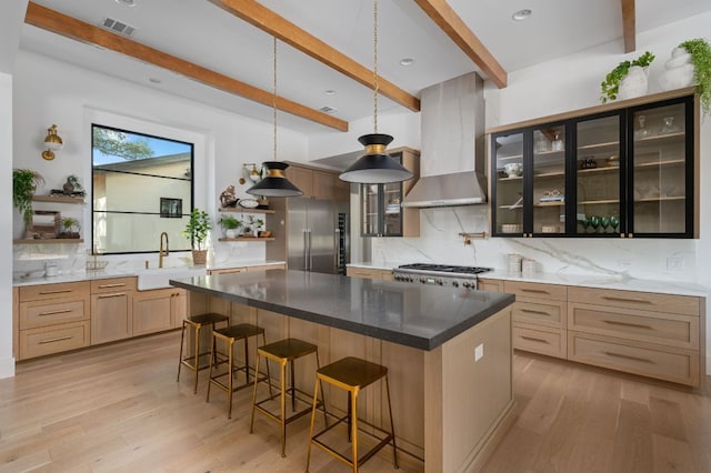 200 Birdstone Ln, Georgetown, TX 78628 - kitchen with open shelves, stainless steel built in fridge, wall chimney range hood, light wood-type flooring, and beamed ceiling