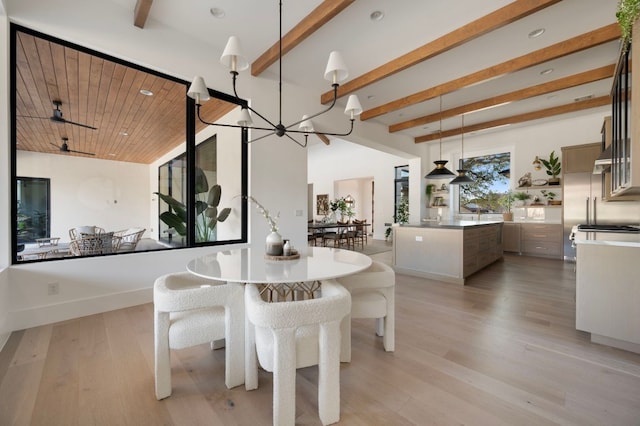 dining room with a chandelier, recessed lighting, baseboards, light wood finished floors, and beamed ceiling