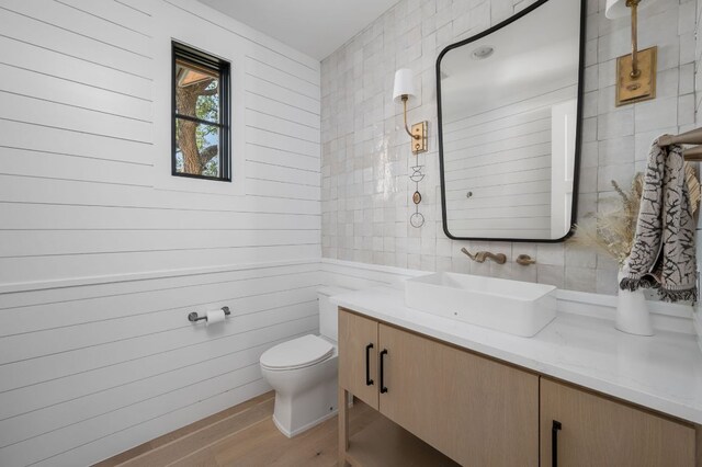 200 Birdstone Ln, Georgetown, TX 78628 - bathroom featuring vanity, wood finished floors, and backsplash