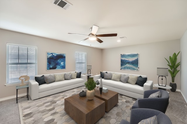 living area with light carpet, visible vents, ceiling fan, and baseboards