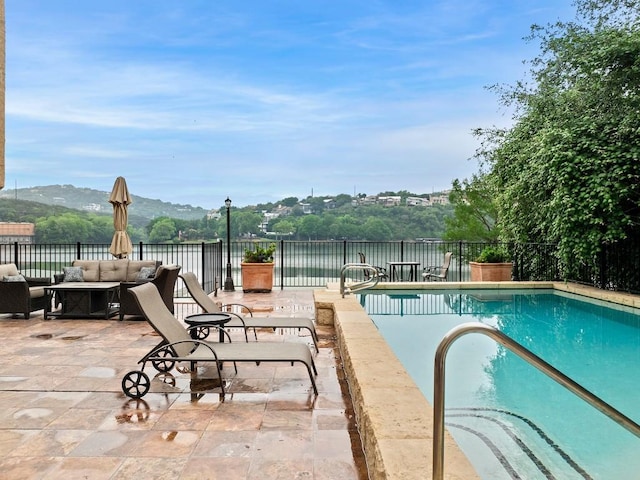 view of pool with an outdoor hangout area, a patio area, fence, and a fenced in pool