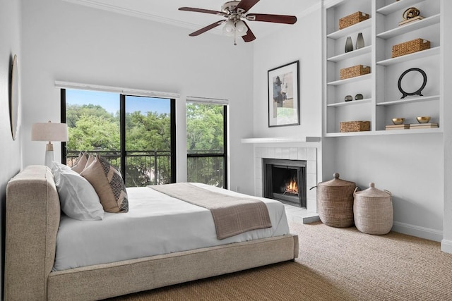 carpeted bedroom with baseboards, a tile fireplace, a ceiling fan, and crown molding