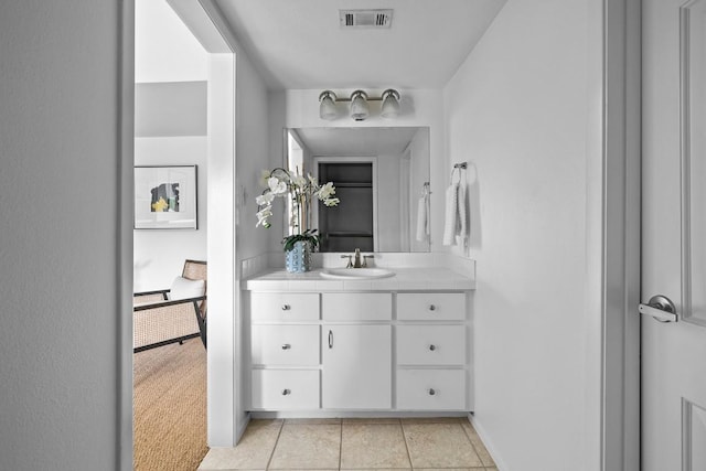 bathroom with tile patterned flooring, visible vents, baseboards, and vanity