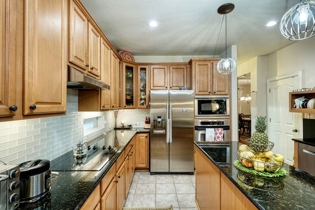 kitchen featuring black appliances, brown cabinetry, backsplash, and glass insert cabinets