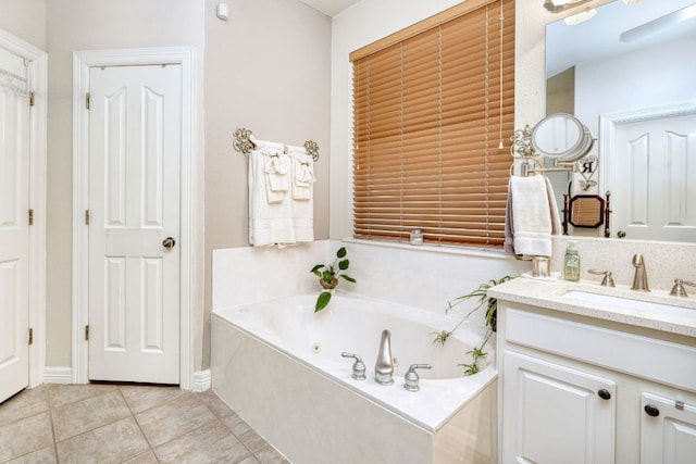 full bathroom featuring a garden tub, vanity, and tile patterned floors