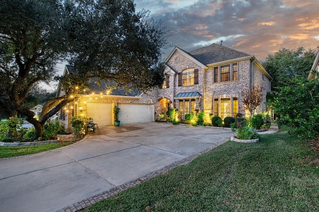 view of front of home featuring concrete driveway, a yard, and an attached garage