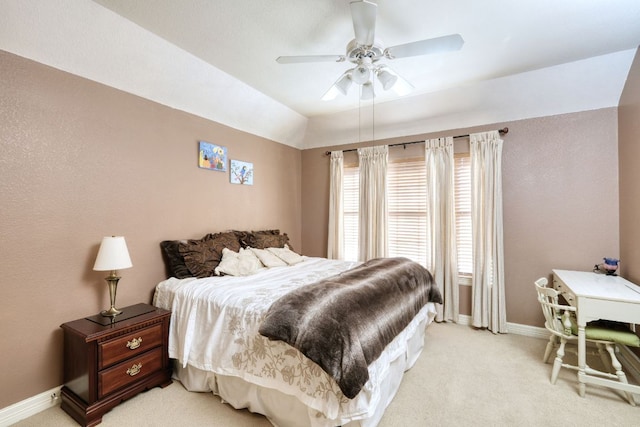 bedroom with ceiling fan, baseboards, vaulted ceiling, and light colored carpet