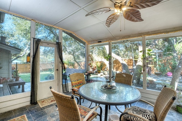 sunroom / solarium featuring ceiling fan