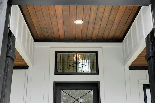 details with wooden ceiling and an inviting chandelier