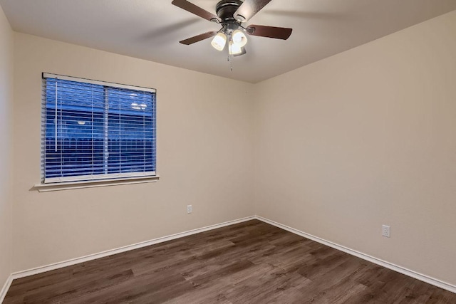 empty room featuring ceiling fan, dark wood-style flooring, and baseboards