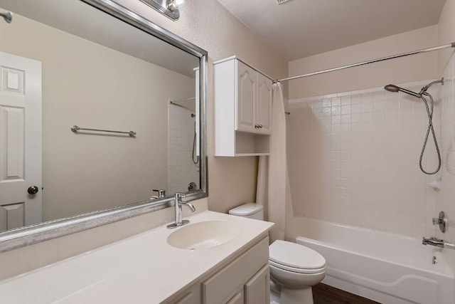 bathroom featuring toilet, shower / bathtub combination, and vanity