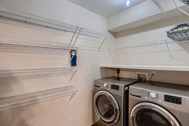 clothes washing area featuring laundry area and separate washer and dryer