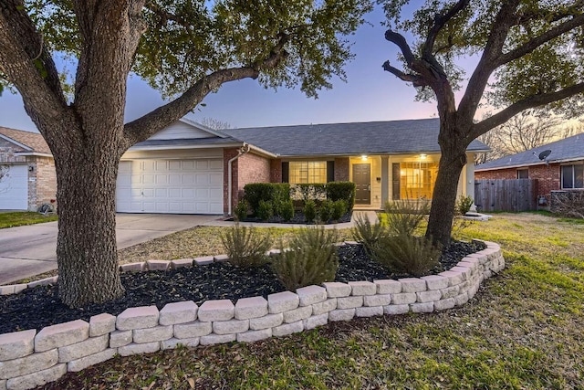 ranch-style home featuring a garage, brick siding, a shingled roof, fence, and driveway